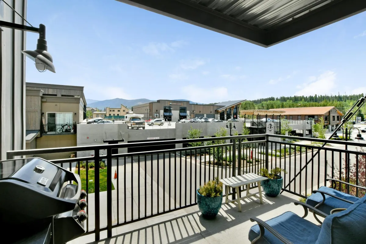 This image showcases a private balcony with comfortable seating, a gas grill, potted plants, and a clear view of the surrounding area—perfect for relaxing, dining, or enjoying the fresh mountain air. The ambiance is casual and relaxed, visually echoing the section's focus on outdoor enjoyment and alfresco living.